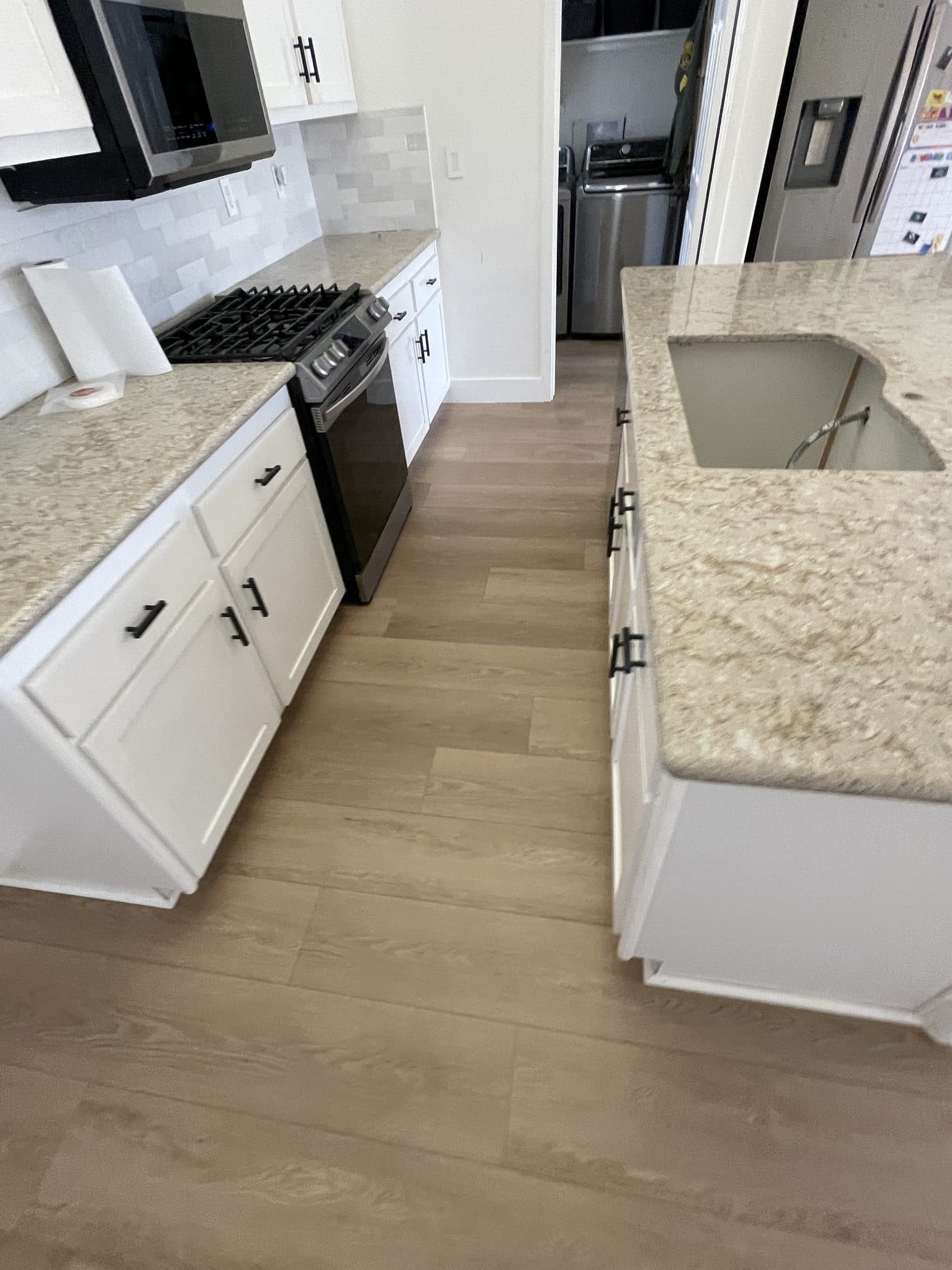 Completed kitchen rebuild in Corona CA with new cabinets, quartz counters and luxury vinyl plank flooring — photo 6