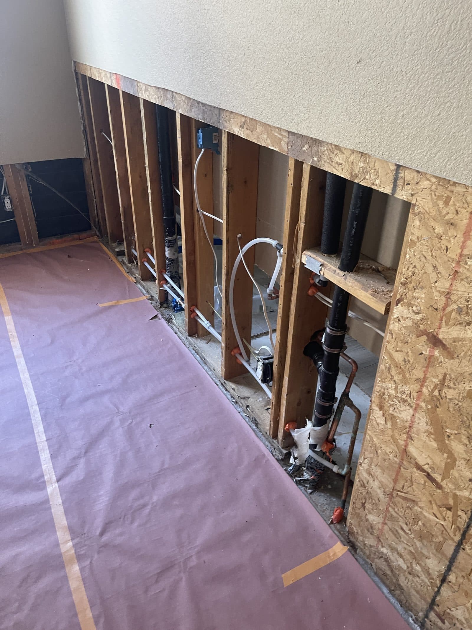 Water damaged wall opened to framing in Corona CA home before insurance claim repair — photo 1