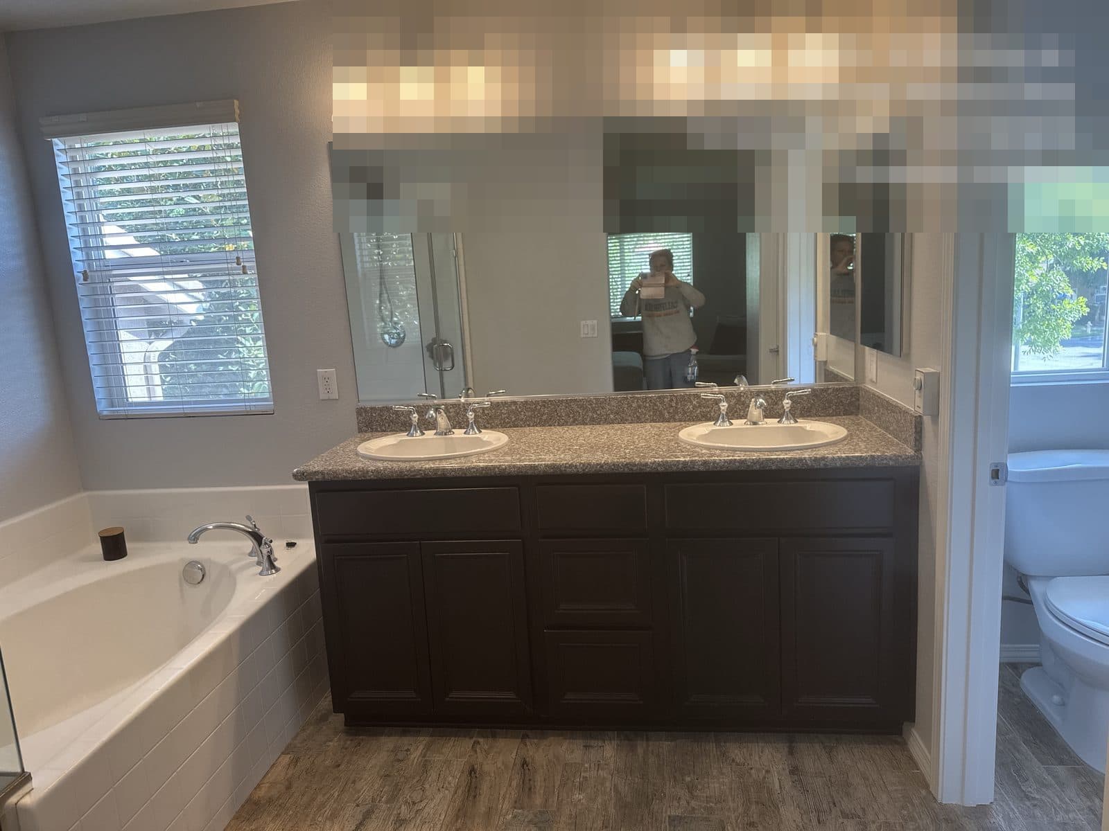 Finished bathroom rebuild in Grand Terrace CA with dual sink vanity and wood-look flooring — photo 2